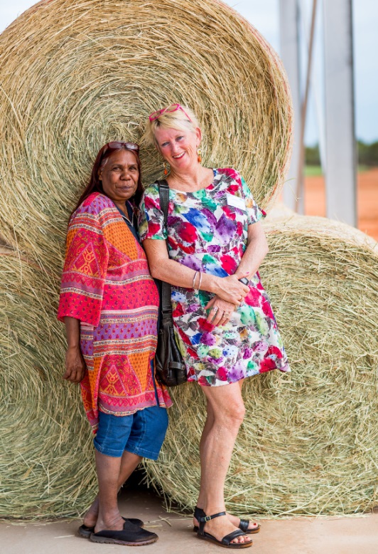 Broome community members with bales of Rhodes grass hay used to fund the West Kimberley Community Grants Scheme